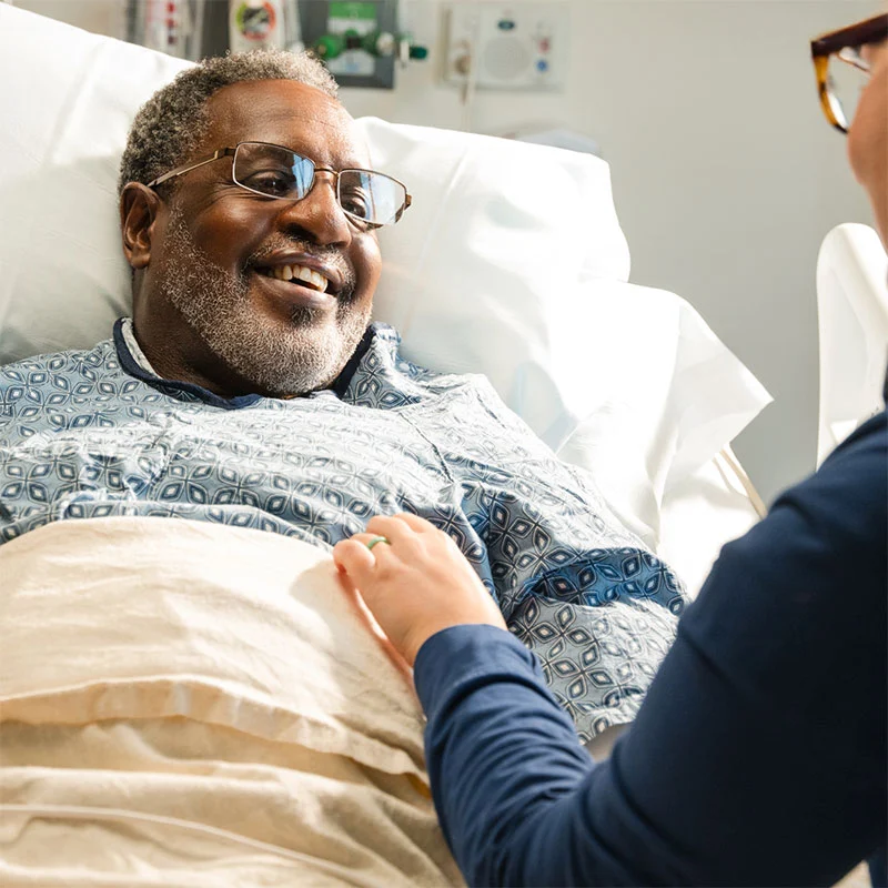 Man smiling in hospital bed Man smiling in hospital bed