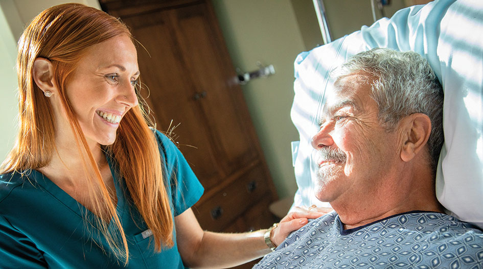 Female nurse smiling with male patient