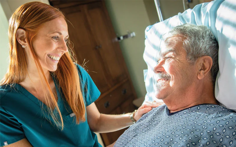 Nurse-with-patient-bedside Nurse-with-patient-bedside