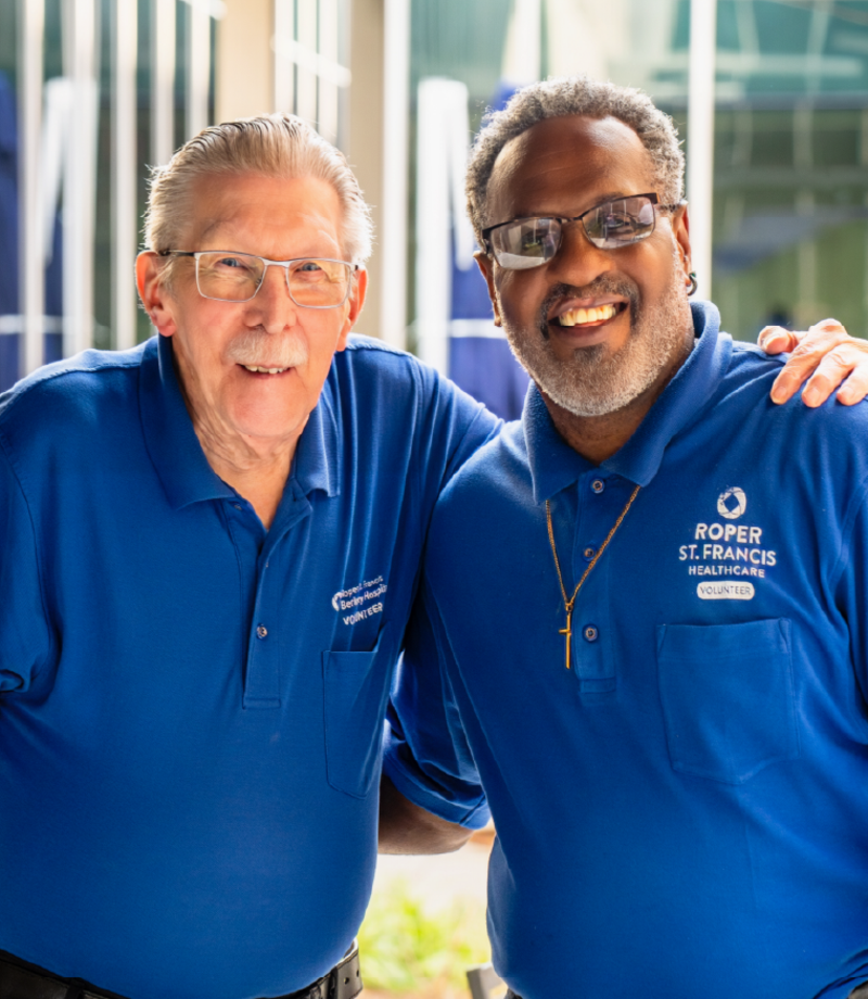 Two volunteers smile ?? ''