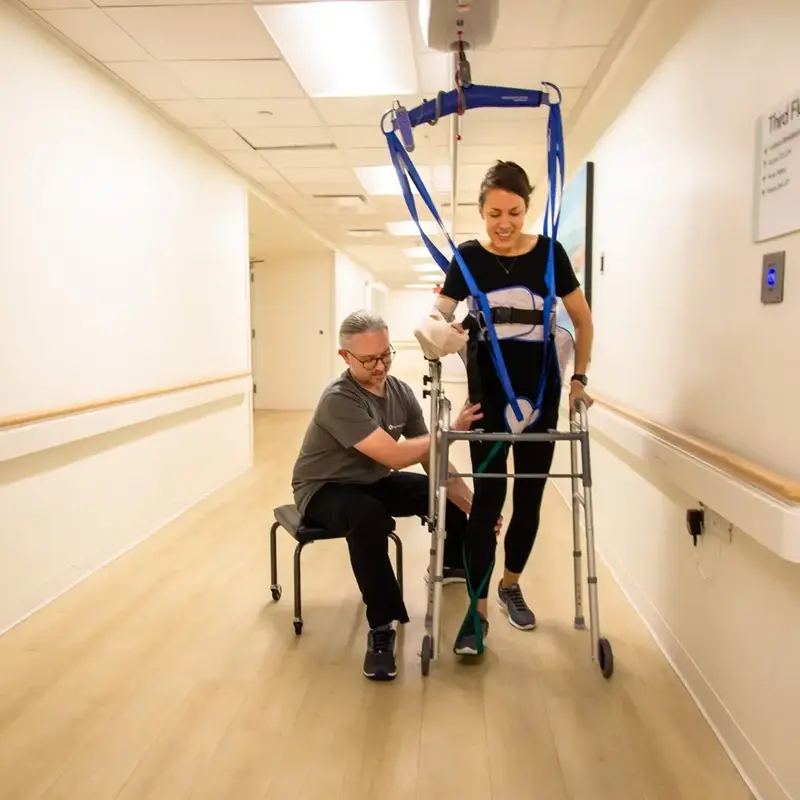 Patient walks with specialty equipment