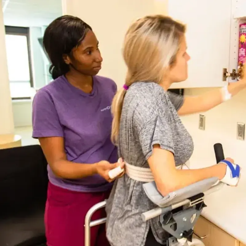 Rehab staff helps patient exercise