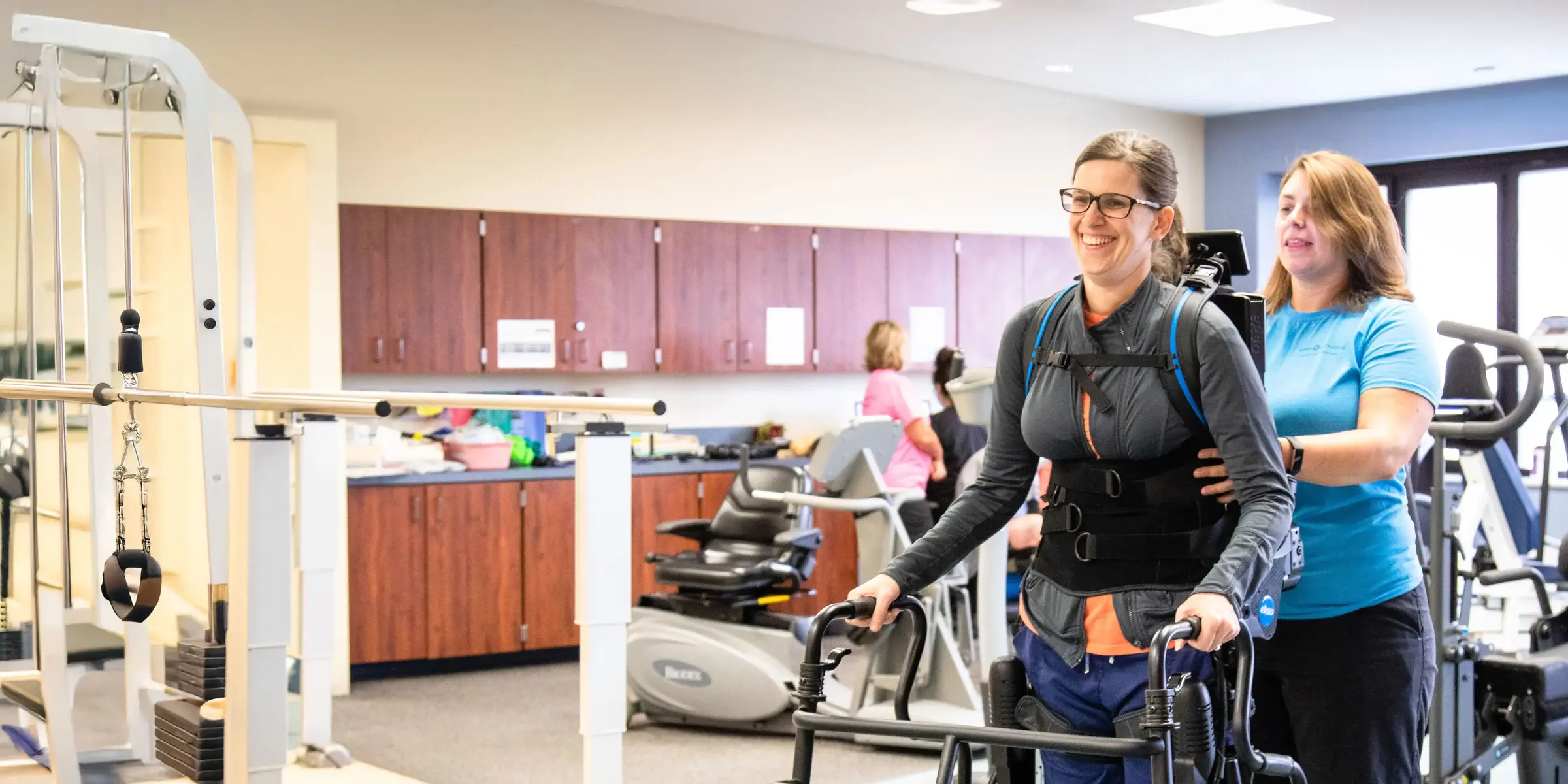 Rehab specialist helps patient use walker