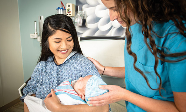 nurse with woman and her newborn baby