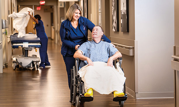 male patient in wheelchair with nurse