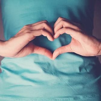 woman making a heart with hands